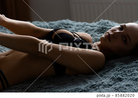 Alluring brunette in black lingerie on bed Alluring brunette in black lingerie on bed 85882020