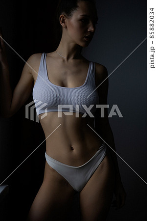 Alluring brunette in white lingerie on bed Alluring brunette in white lingerie on bed 85882034