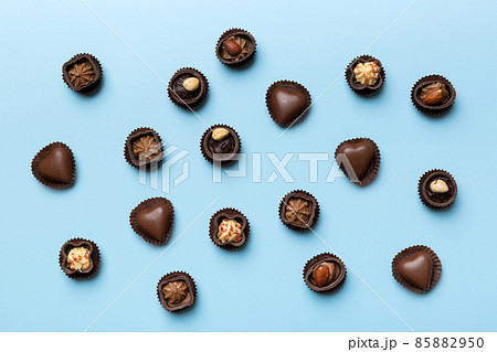 Different kinds of chocolates on colored table close-up. Top View and Flat Lay Different kinds of chocolates on colored table close-up. Top View and Flat Lay 85882950