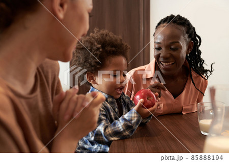 Mother Giving Apple to Son Mother Giving Apple to Son 85888194