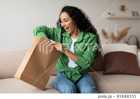 Joyful Customer Woman Unpacking Package After Successful Shopping At Home Joyful Customer Woman Unpacking Package After Successful Shopping At Home 85888555