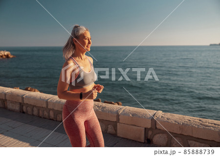 Adult athletic lady training by the waterfront 85888739