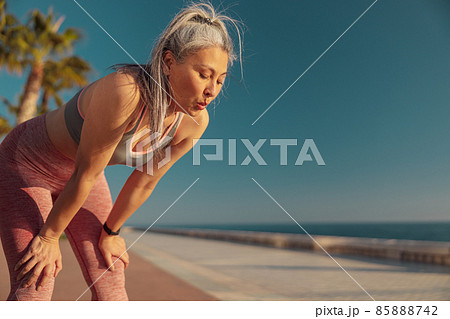 Strong lady resting by the coast after hard training Strong lady resting by the coast after hard training 85888742