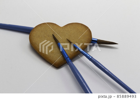 heart shaped cookies on white background with blue paintbrushes, food decoration, Pastry art, cookies decoration, horizontal, copy space heart shaped cookies on white background with blue paintbrushes, food decoration, Pastry art, cookies decoration, horizontal, copy space 85889493