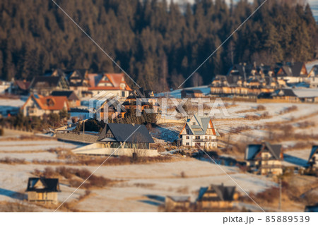 Dark landscape tilt-shift houses background. Tilt-shift miniature effect of winter scenery. 85889539