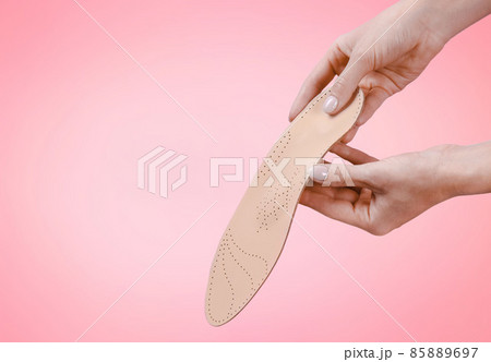 Orthopedic insole isolated on a pink background. Medical insoles. Treatment and prevention of flat feet and foot diseases. Foot care, feet comfort. Wear comfortable shoes. Flat Feet Correction. Orthopedic insole isolated on a pink background. Medical insoles. Treatment and prevention of flat feet and foot diseases. Foot care, feet comfort. Wear comfortable shoes. Flat Feet Correction. 85889697
