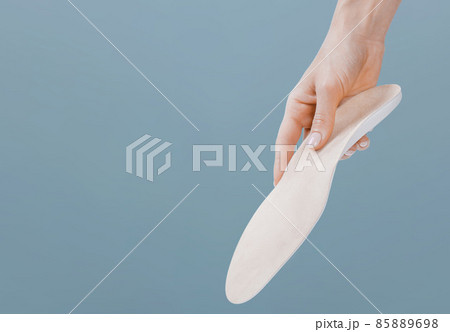 Orthopedic insole isolated on a blue background. Medical insoles. Treatment and prevention of flat feet and foot diseases. Foot care, feet comfort. Wear comfortable shoes. Flat Feet Correction. Orthopedic insole isolated on a blue background. Medical insoles. Treatment and prevention of flat feet and foot diseases. Foot care, feet comfort. Wear comfortable shoes. Flat Feet Correction. 85889698