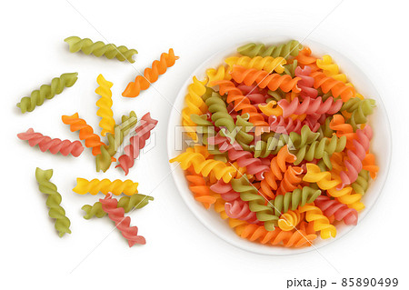 raw Fusilli colored pasta in ceramic bowl isolated on white background with clipping path and full depth of field. Top view. Flat lay raw Fusilli colored pasta in ceramic bowl isolated on white background with clipping path and full depth of field. Top view. Flat lay 85890499
