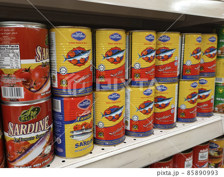 PENANG, MALAYSIA -DECEMBER 09, 2021: Selective focused on sardine fish can. The fish has been processed, cook and packed in the can. Displayed on the rack for sale and tag with the price tag 85890993