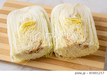 Rotten chinese cabbage cut in half on a chopping board. Rotten chinese cabbage cut in half on a chopping board. 85891257