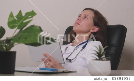 Smiling young female therapist using online healthcare app on digital computer tablet, planning patients appointment in clinic office. Happy doctor general practitioner holding touchpad in hands Smiling young female therapist using online healthcare app on digital computer tablet, planning patients appointment in clinic office. Happy doctor general practitioner holding touchpad in hands 85891955