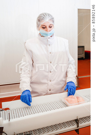 Line for the production of semi-finished meat products.Meat processing in food industry.Packing of meat slices in boxes on a conveyor belt.modern poultry processing plant. Line for the production of semi-finished meat products.Meat processing in food industry.Packing of meat slices in boxes on a conveyor belt.modern poultry processing plant. 85892146