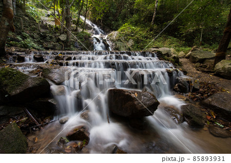 The famous natural waterfall in Maekampong village,Chiangmai province,Thailand.Yellow sign means caution waterfall ahead in thai language.Attractive place for traveller. 85893931