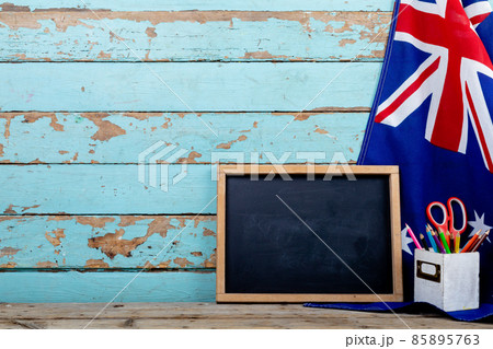 Blank writing slate with copy space by desk organizer on australia flag over table 85895763