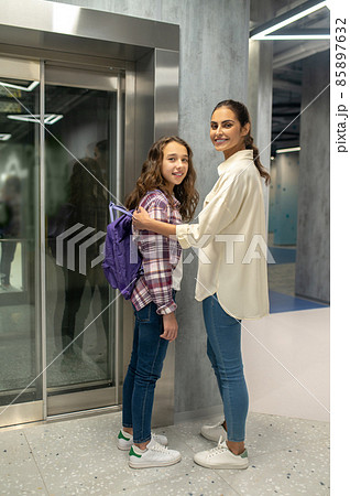 Girl and a young woman waiting for the passenger elevator Girl and a young woman waiting for the passenger elevator 85897632