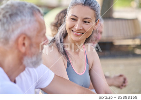 Mid aged people resting in the park after the workout Mid aged people resting in the park after the workout 85898169