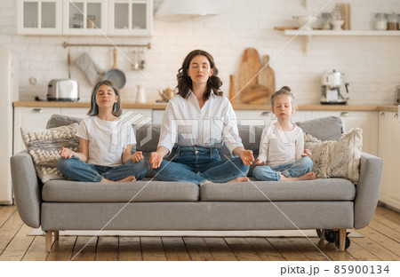 Woman and children are meditating Woman and children are meditating 85900134