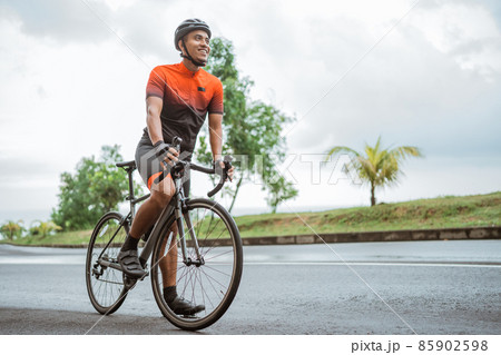happy smiling road bike cyclist while riding his bike outdoor 85902598