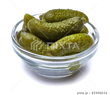 Bowl of Tasty canned Whole green cornichons isolated on a white background Bowl of Tasty canned Whole green cornichons isolated on a white background 85906634
