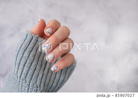 Stylish blue female nails. Modern trendy stylish Beautiful manicure. Autumn winter nail minimalistic design concept of beauty treatment. Gel nails. Skin care. Copy space for text. Beautician Stylish blue female nails. Modern trendy stylish Beautiful manicure. Autumn winter nail minimalistic design concept of beauty treatment. Gel nails. Skin care. Copy space for text. Beautician 85907027