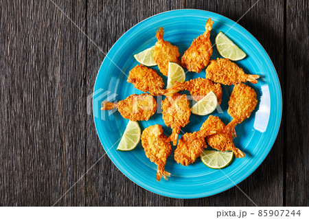 Crispy Fried Butterfly Shrimp on a blue plate Crispy Fried Butterfly Shrimp on a blue plate 85907244