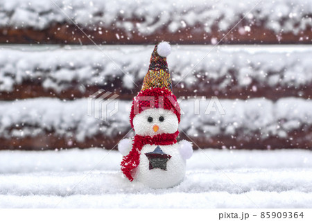 Merry christmas and happy new year greeting card with copy space Happy little snowman in red cap and scarf standing in winter snow background Xmas fairytale Hello January, February concept 85909364