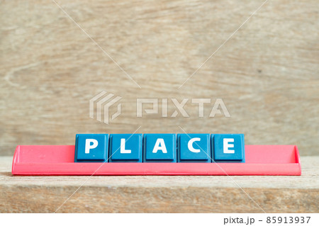 Tile alphabet letter with word place in red color rack on wood background 85913937