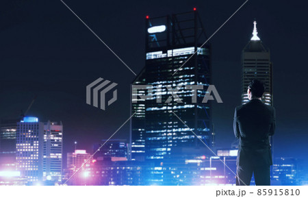 Businessman viewing night glowing city 85915810