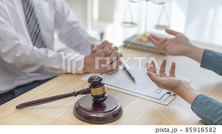 Client describes the money fraud problem and discusses the solution with a lawyer in the litigation room, Ethics in the courts include justice, legal consultant, Scales of justice, Litigation. 85916582