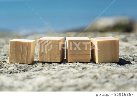 Wooden block on old tree stump with blurred background of ocean 85916867
