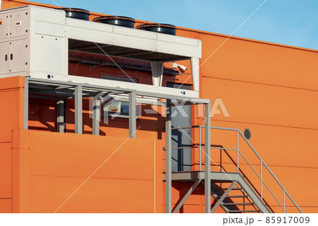 Air conditioner units on a wall of industrial building Air conditioner units on a wall of industrial building 85917009