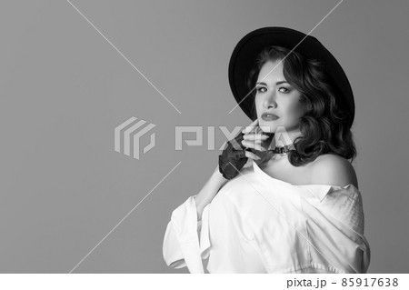 Half-length monochrome portrait of young beautiful woman posing isolated on gray studio background. Beauty, fashion, style, bodypositive concept 85917638