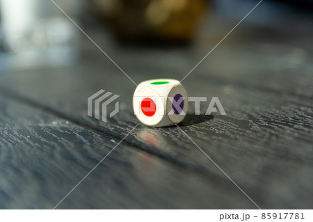 Dice with colored dots on the table Dice with colored dots on the table 85917781