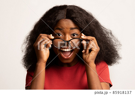 Wow. Surprised Black Female Taking Off Glasses, Looking At Camera With Excitement Wow. Surprised Black Female Taking Off Glasses, Looking At Camera With Excitement 85918137