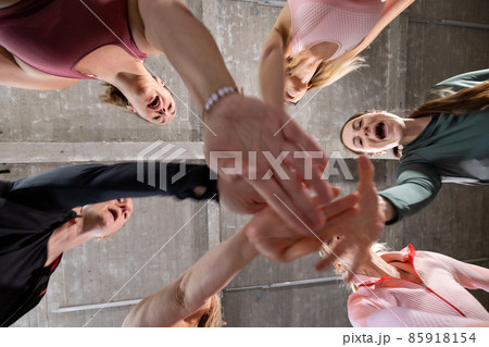 Group of six young motivated sporty girls wearing sports attire standing together forming hand stack Group of six young motivated sporty girls wearing sports attire standing together forming hand stack 85918154