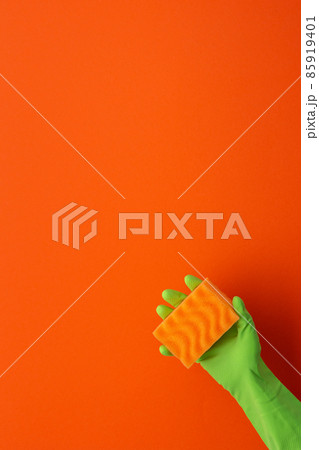 Hand in rubber gloves hold a dishwashing sponge Hand in rubber gloves hold a dishwashing sponge 85919401