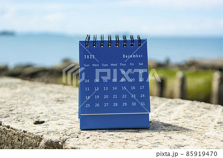 Blue December 2022 calendar on blurred background of blue ocean 85919470