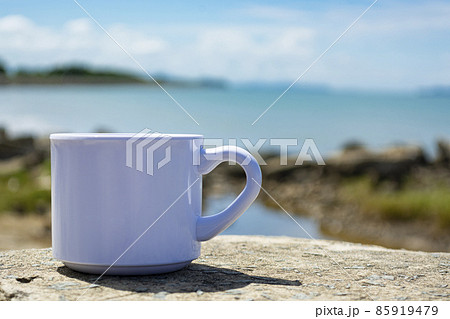 Empty white cup on blurred beach background 85919479