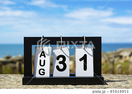 Aug 31 calendar date text on wooden frame with blurred background of ocean 85919953
