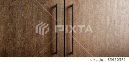 Modern minimalistic kitchen with black and wooden surfaces, marble kitchen island top and household appliances. Modern Concept For Interior Design And Architecture. 85920572