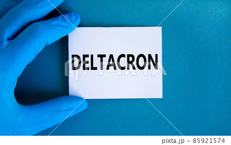 Covid-19 corona deltacron variant symbol. Hand in blue glove with white card. The concept word Deltacron. Medical and COVID-19 corona deltacron variant concept. Copy space. 85921574