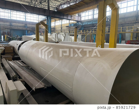 Production of large diameter steel pipes at a metallurgical plant. Soft focus. Close-up 85921729
