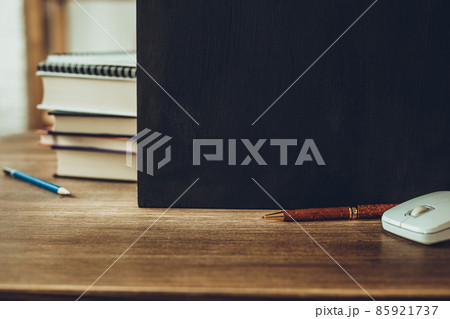 Chalkboard and school supplies on table. Student home workplace 85921737