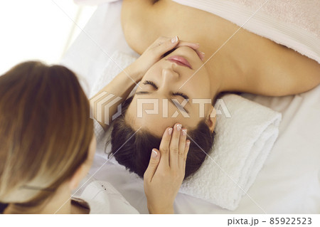 Top view close up of dermatologist make skincare procedures for healthy flawless face skin for client in beauty salon. Cosmetologist do lifting facial massage for woman in clinic. Cosmetology. 85922523