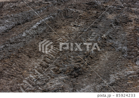 Wet dirt road after rain. Clay, dirt and soil at cloudy day light in autumn season. Wet dirt road after rain. Clay, dirt and soil at cloudy day light in autumn season. 85924233