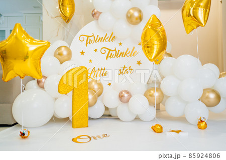 A photo zone for the first birthday of white and gold balloons and a figure one A photo zone for the first birthday of white and gold balloons and a figure one 85924806