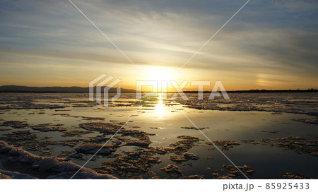 Beautiful orange sunset over the river, ice drift Beautiful orange sunset over the river, ice drift 85925433