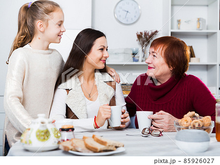 Happy family over cup of coffee at home Happy family over cup of coffee at home 85926027