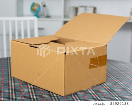 One cardboard box on top of table One cardboard box on top of table 85926188