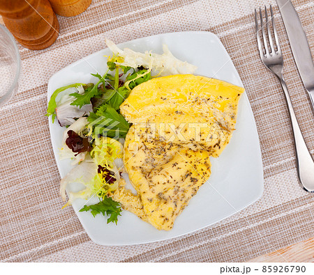 Omelet and arugula on a white plate. Delicious breakfast Omelet and arugula on a white plate. Delicious breakfast 85926790